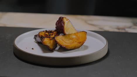 slow motion shot of a chef plating a gourmet sweet potato dish in a restaurant