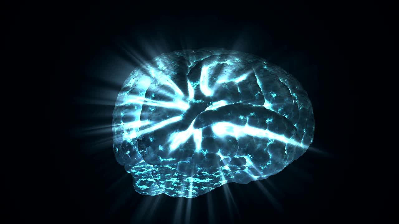 Glowing human brain rotating around on black background. Light is shining through brain. 3D rendered looping animation.