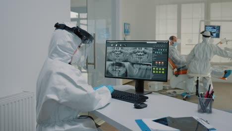 stomatological assistant examining x ray of dentition