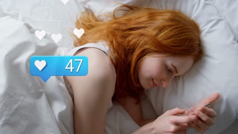 animation of social media reactions over caucasian woman using smartphone in bed