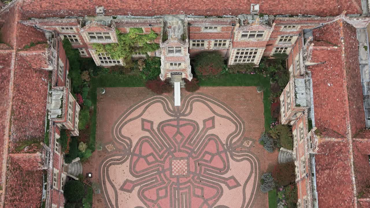 Top View Of The Kentwell Hall Moated Tudor Stately Home In Long Melford, Suffolk, England, UK. Aerial Tilt-down Shot