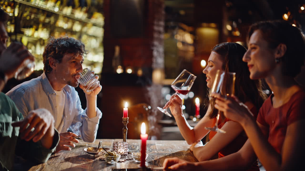 Carefree friends cheering glasses celebrating friendly event in bar closeup