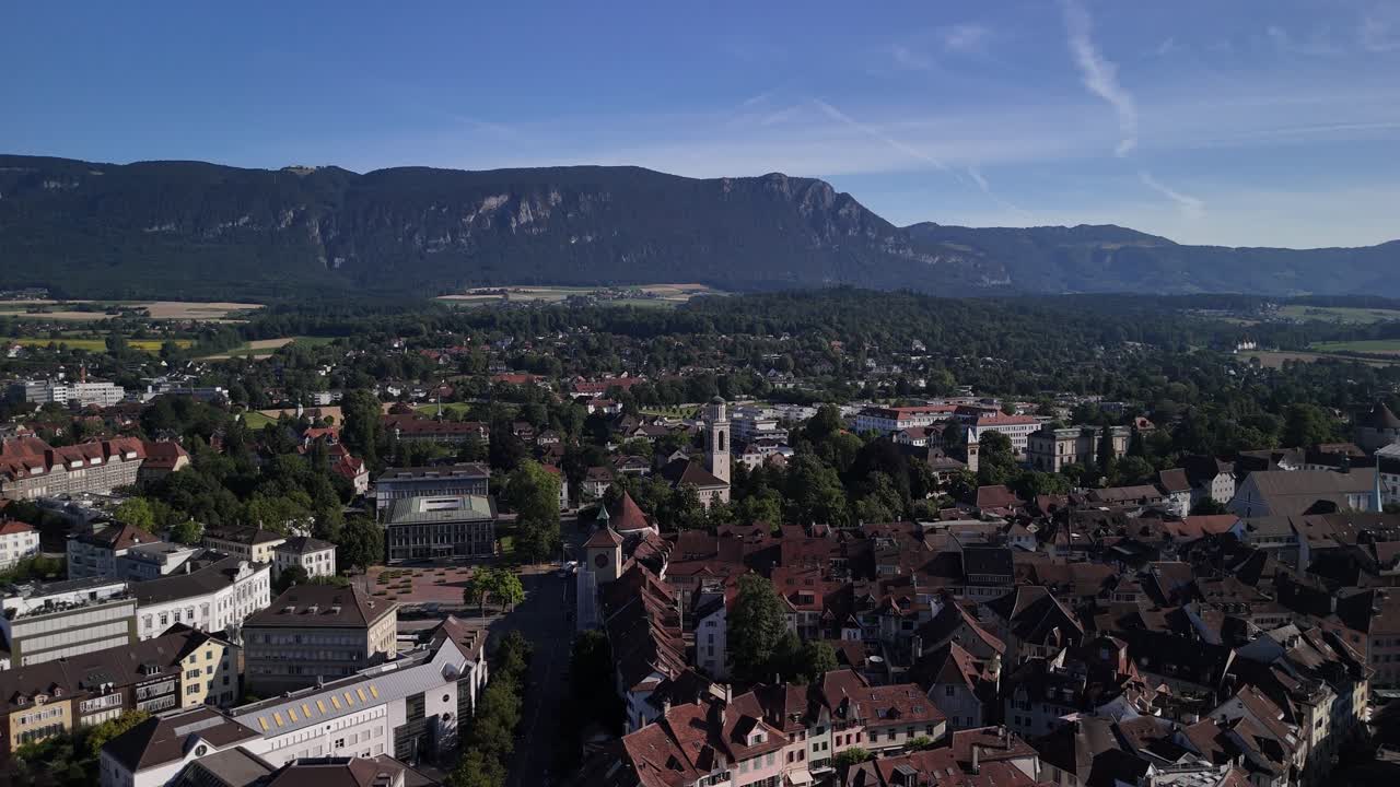 Aerial view of a town with a mountain backdrop