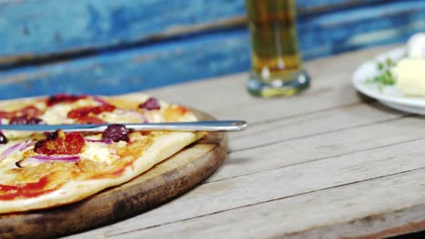 Delicious-pizza-on-wooden-table