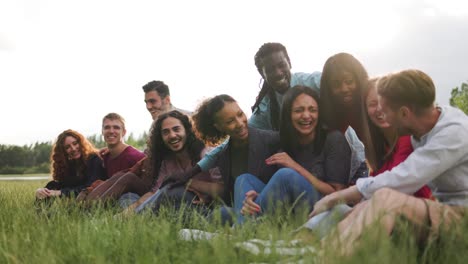 multiracial happy young group of people having fun outdoor by the lake