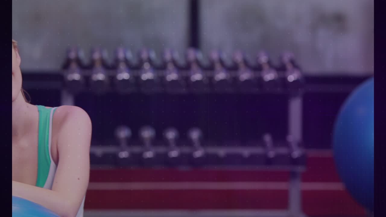 Woman leaning on blue ball in gym, shifting posture upon animated charts appearing to show metrics