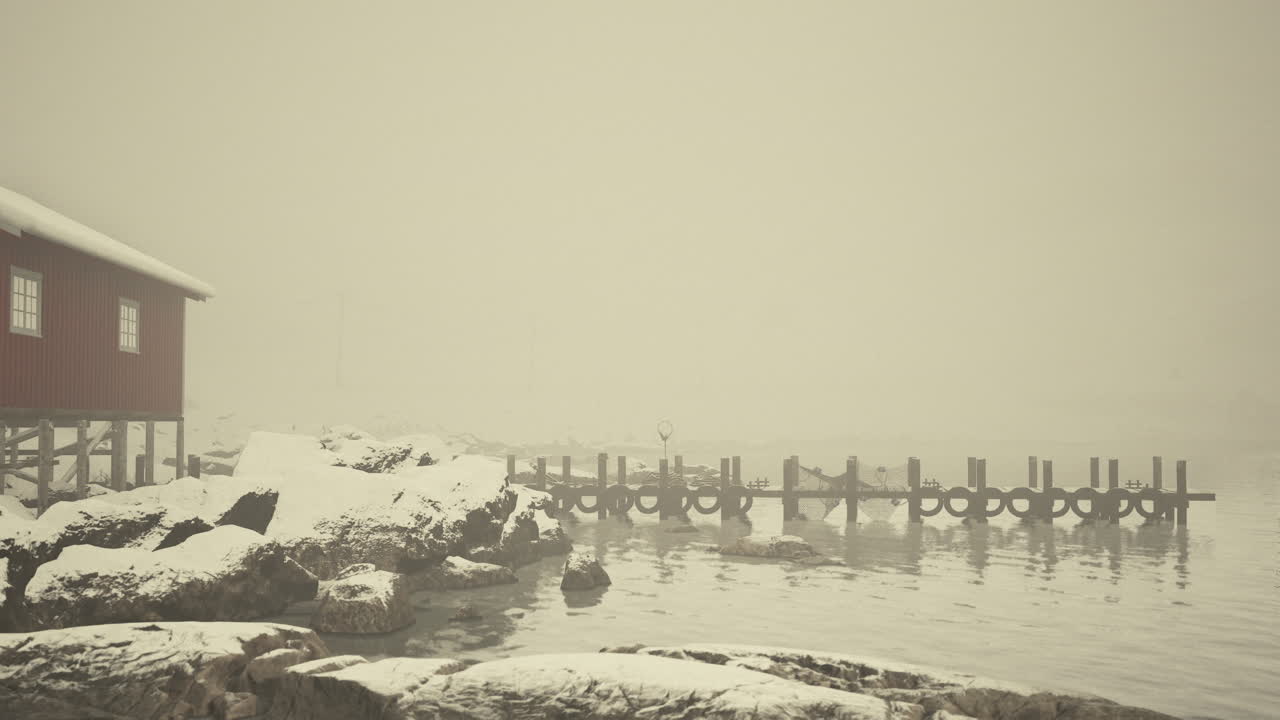 Red building adjacent to snowcovered water
