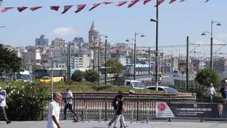 a bustling street scene in istanbul, turkey, with the galata tower in the background.