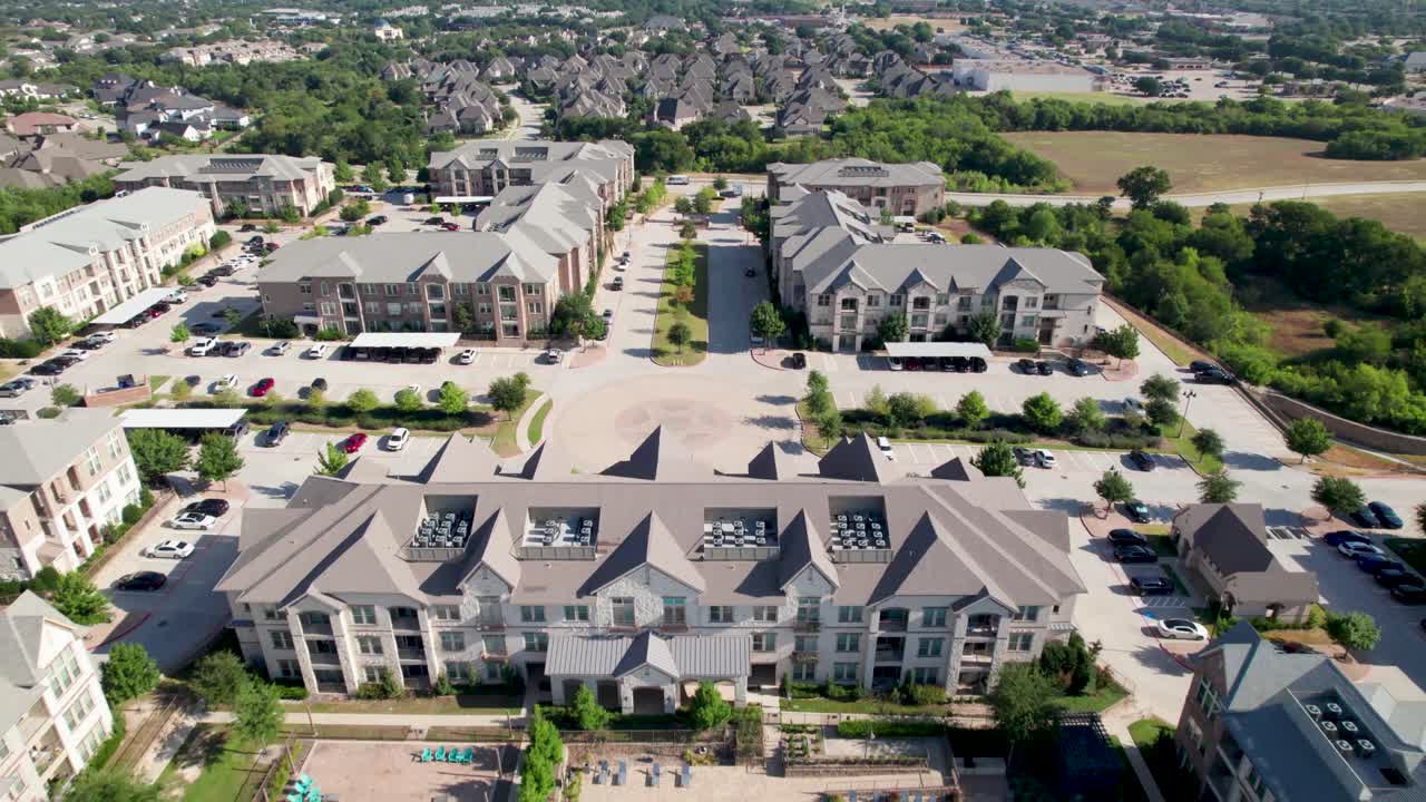 Aerial footage of Atherton apartment complex in Frisco, Texas located at 8655 Brookhollow Blvd, Frisco, TX 75034. Camera flies straight ahead approximately heading north,