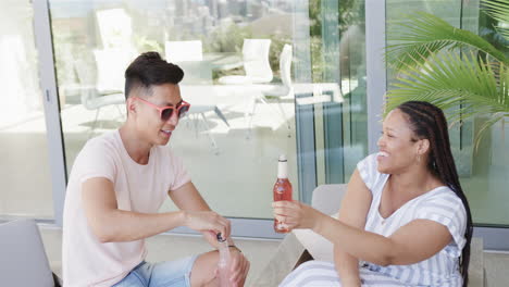 young asian man and young biracial woman enjoy a sunny outdoor setting