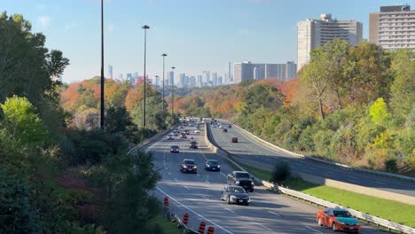 don valley parkway traffic flowing with cars, trucks, motorcycles during fall morning commute