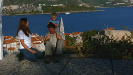 family enjoying a view of a coastal city