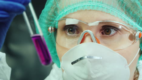 female researcher works in the laboratory with test tubes and chemicals 3