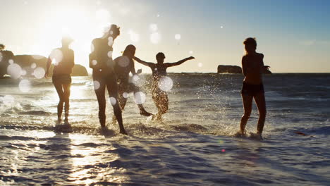 women playing on the beach at susnet against white bubbles