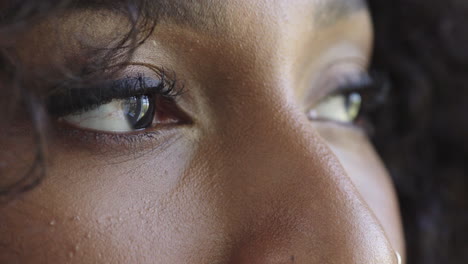 close up beautiful african american woman eyes open looking pensive contemplative blinking healthy eyesight