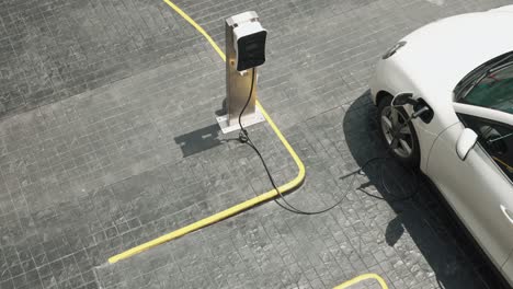 progressive innovation urban electric on-street charging station with ev car.