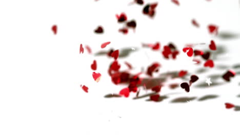 animation of red hearts and white stars falling on white background