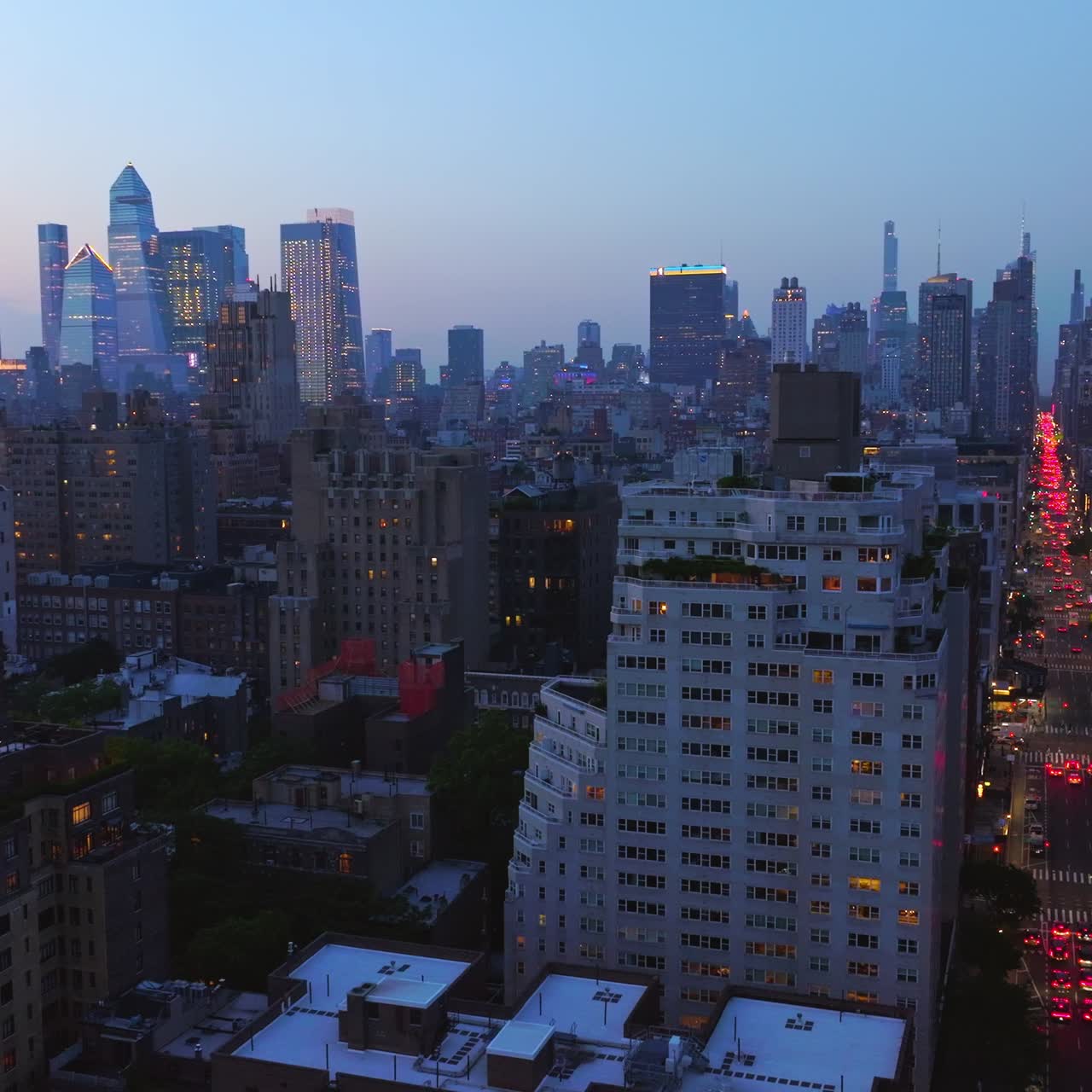 Never sleeping New York with thousands of lights on. Crazy traffic on the busy streets of vibrant metropolis. Skyscrapers in lights at background