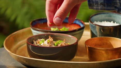 preparing a dish with garnishes