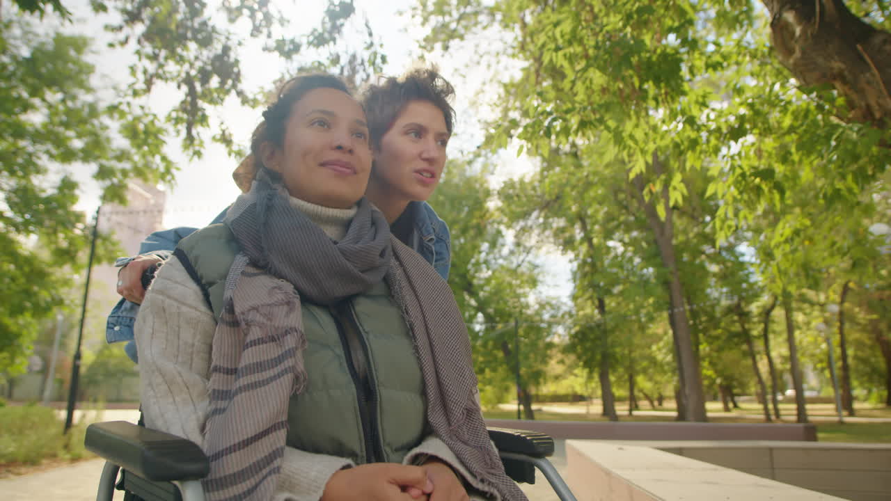 Woman in Wheelchair with Friend in Park