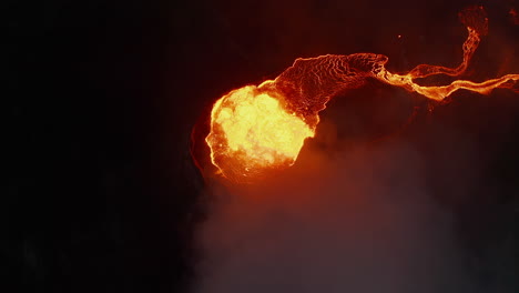 Aerial-birds-eye-overhead-top-down-view-of-boiling-magma-in-active-volcano-crater-at-night.-Fagradalsfjall-volcano.-Iceland,-2021