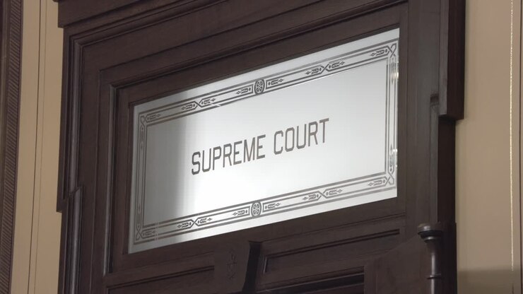 Old Supreme Court door sign inside the Michigan state capitol with stable video.