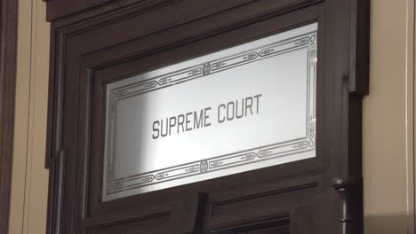 Old Supreme Court door sign inside the Michigan state capitol with stable video.