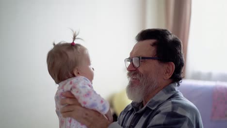 grandfather with a beard wearing glasses playing