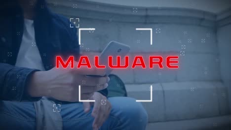 animación de alcance sobre texto de malware sobre hombre biracial usando teléfono inteligente sentado en las escaleras.