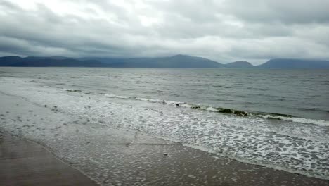 Birds-fly-over-ocean-waves-in-ireland