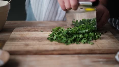 chef cutting parsley herbs finely