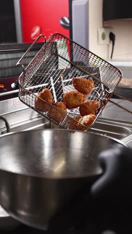 deep frying food in a restaurant kitchen