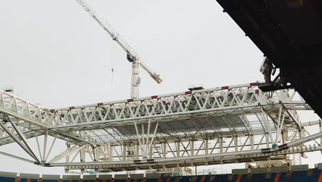 tower crane working on roof structure of a football stadium being constructed in madrid, spain