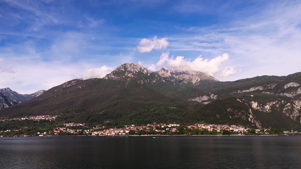 Fly sideways, view of high mountain, Mandello del Lario, Lake Como and more, Italy