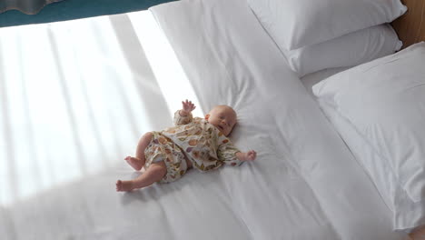 cute baby girl on white bed linen