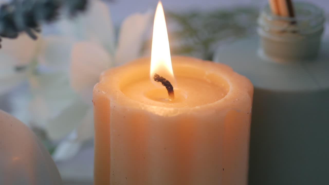 Relaxing Spa Scene with Burning Candle and Flowers