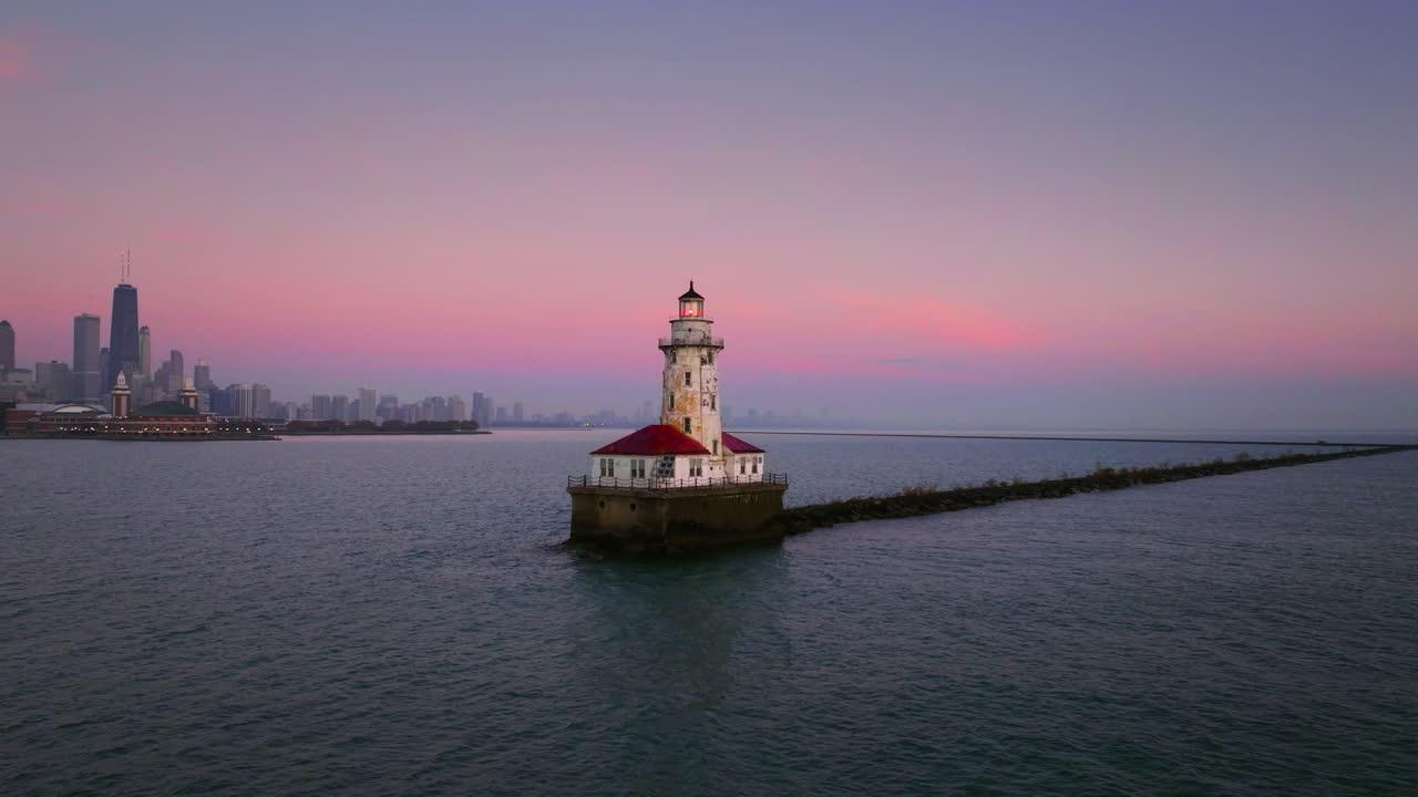 Chicago lighthouse with city skyline in background at sunrise aerial