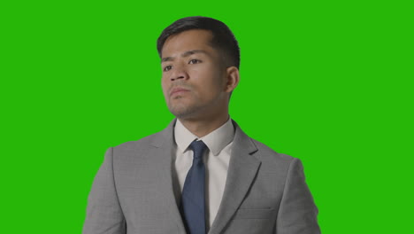 Portrait-Of-Serious-Businessman-In-Suit-Against-Green-Screen-Looking-At-Camera-1