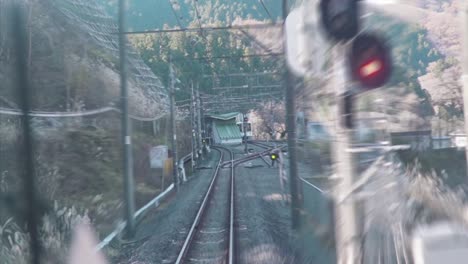 train driver eye view - train moving through tunnels by the forest in tokyo, japan.  - pov - timelapse