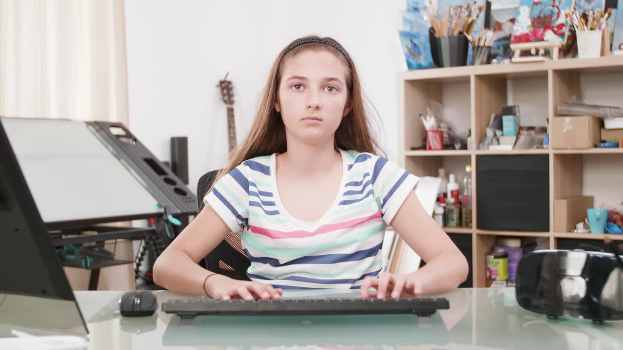 Girl Typing on Computer at Desk