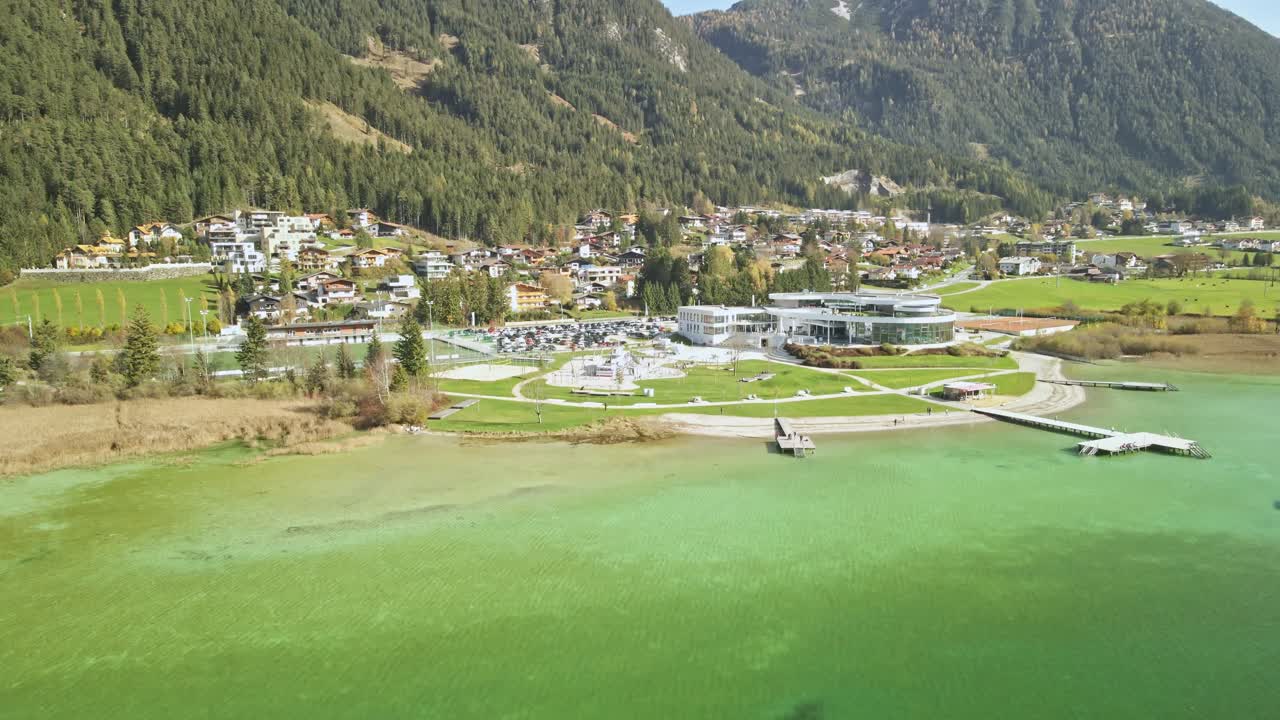 A stunning drone shot flying towards the Atoll in Achensee on a sunny summer day. The video showcases vibrant turquoise water, and the beauty of this Austrian lake.