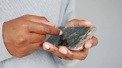 person holding a broken smartphone