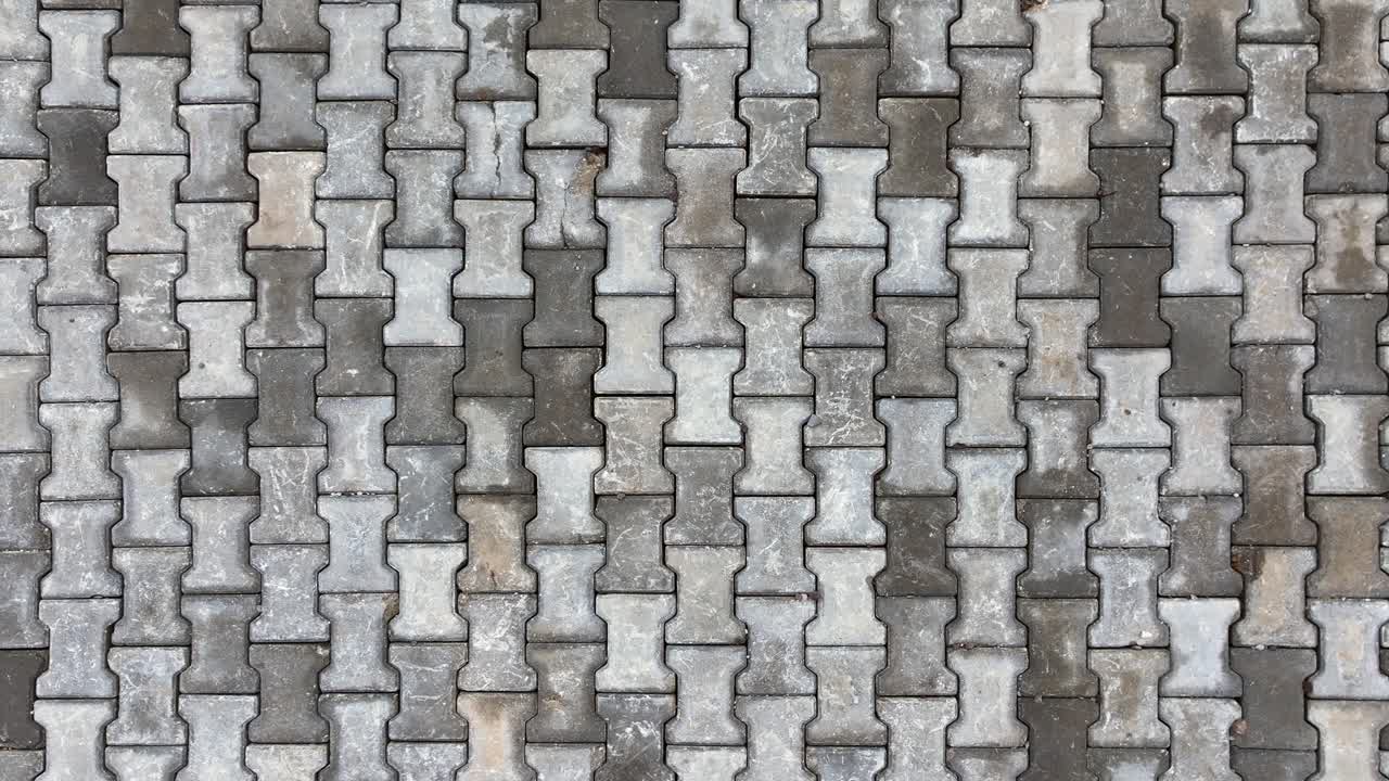 Top view of interlocking paving stone texture. Outdoor concrete slab pavement high quality drone image