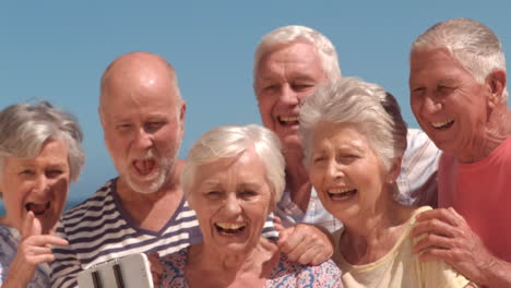 group of mature people taking a photo