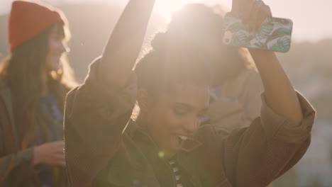 woman dancing multi ethnic friends  celebrating on rooftop at sunset enjoying party weekend having fun socializing hanging out drinking