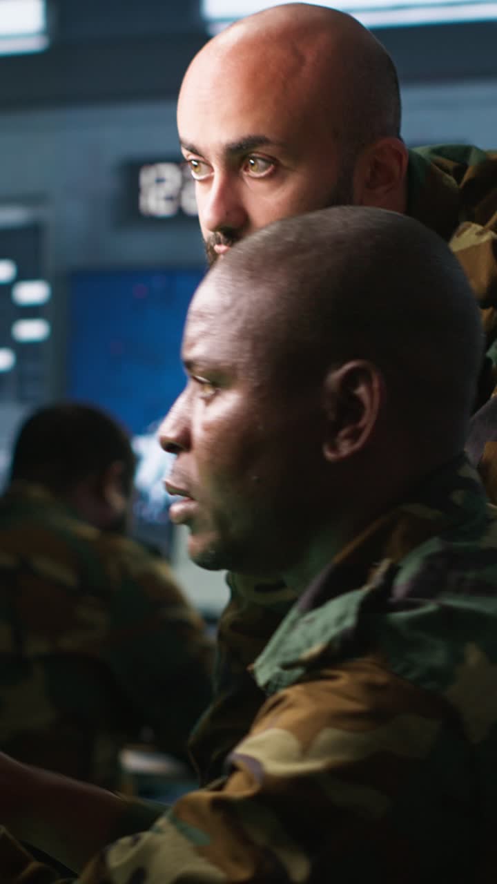 Vertical video Military soldiers using radar devices to look at assault zones on displays