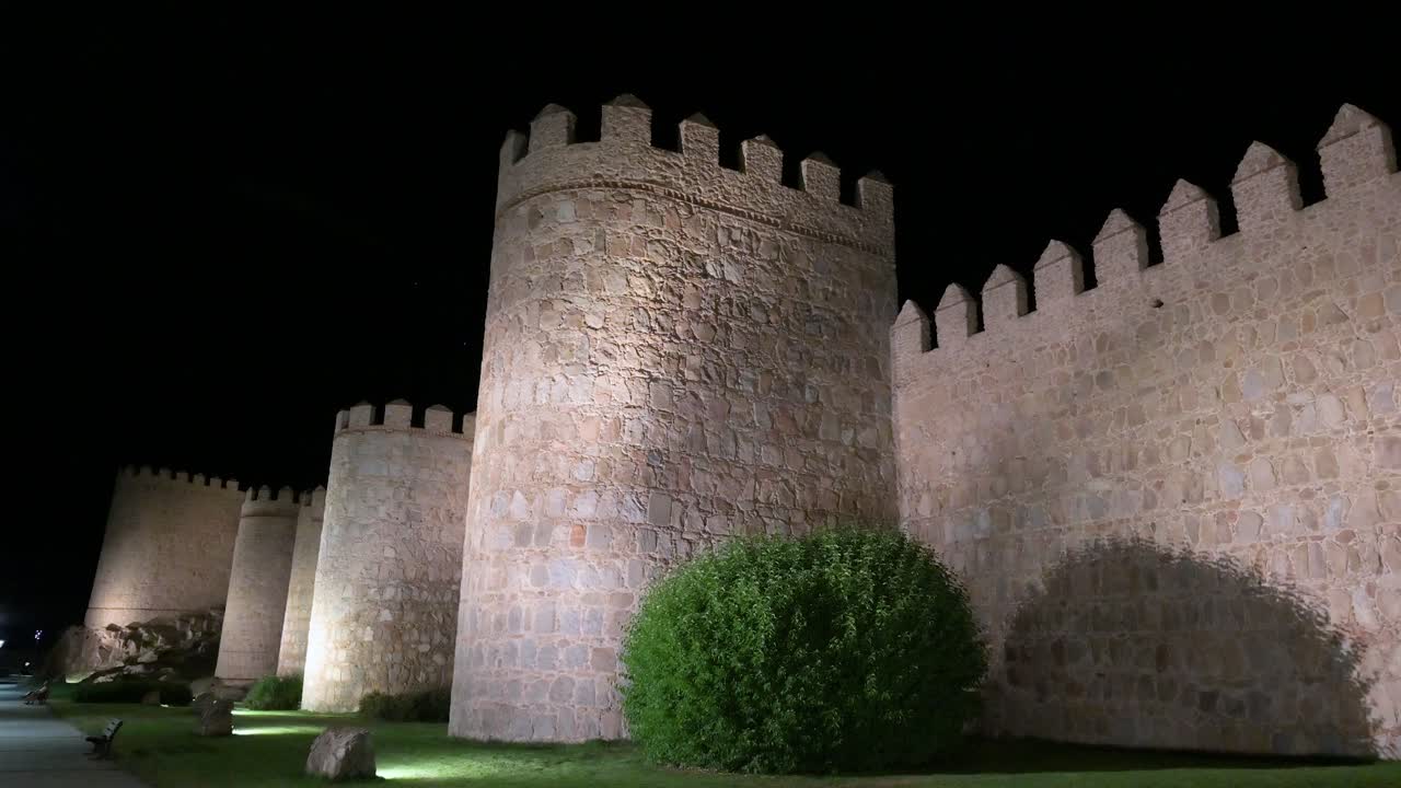 The old town of Avila after dark, with its UNESCO-protected medieval walls shining brightly.