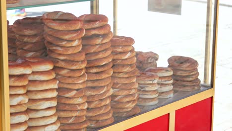 stacks of turkish simit bagels at a street food stall