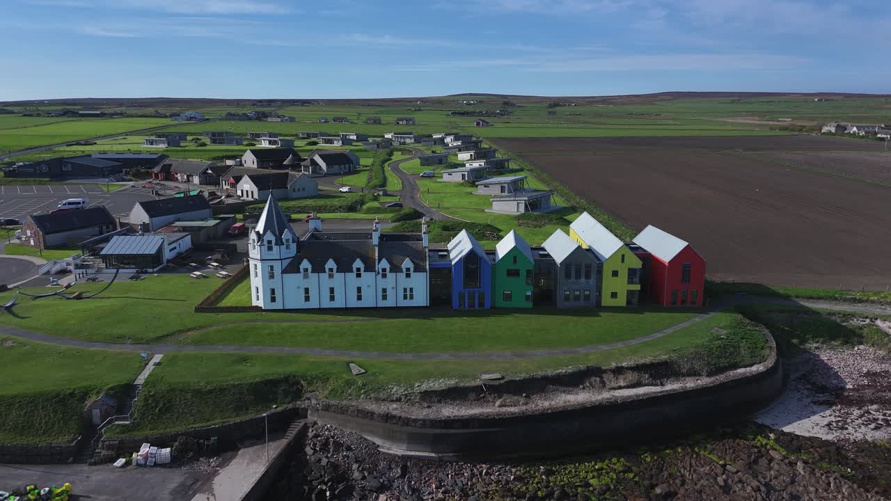 Aerial shot of the colourful holiday homes at the seafront at John O'Groats