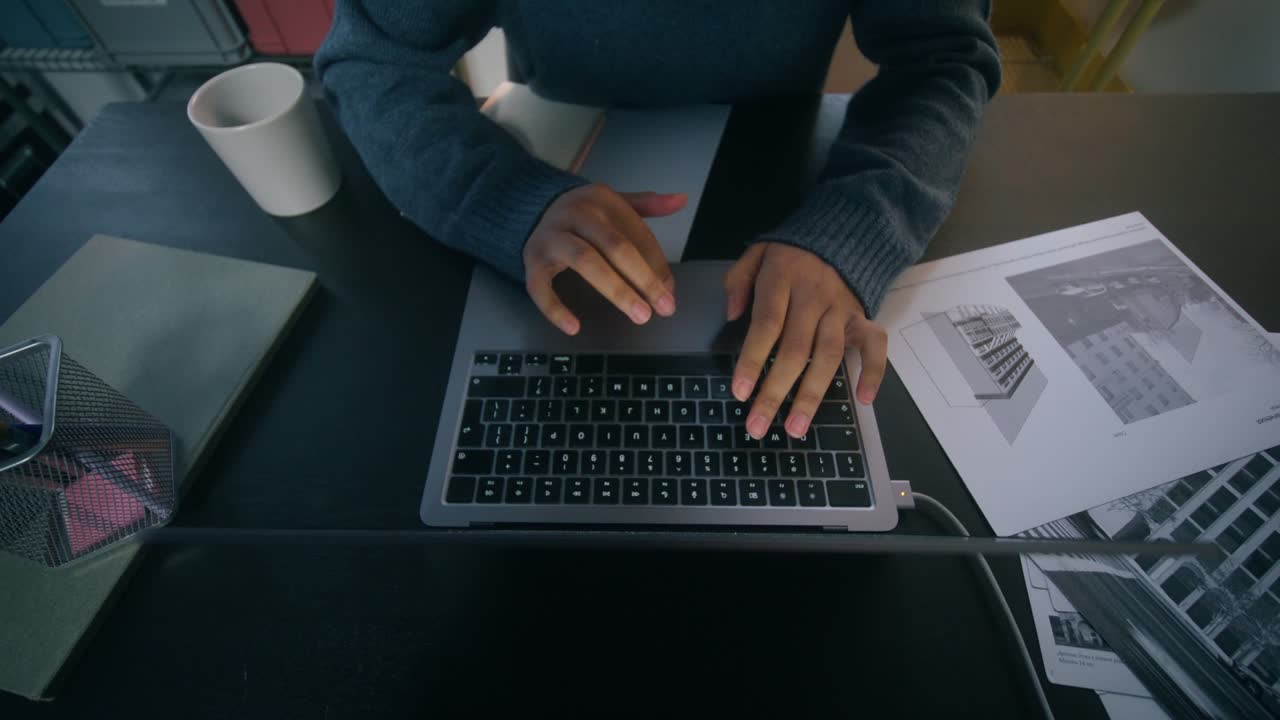 Person Working on Laptop in an Office